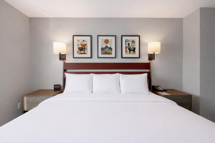 Guest room with a king bed with three pillows