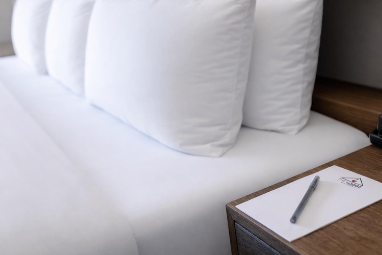 Closeup of a notepad beside a bed