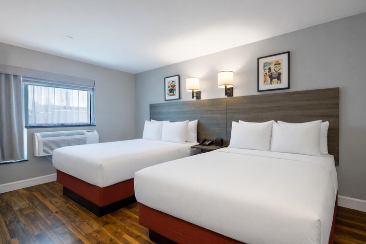 A guest room with two double beds