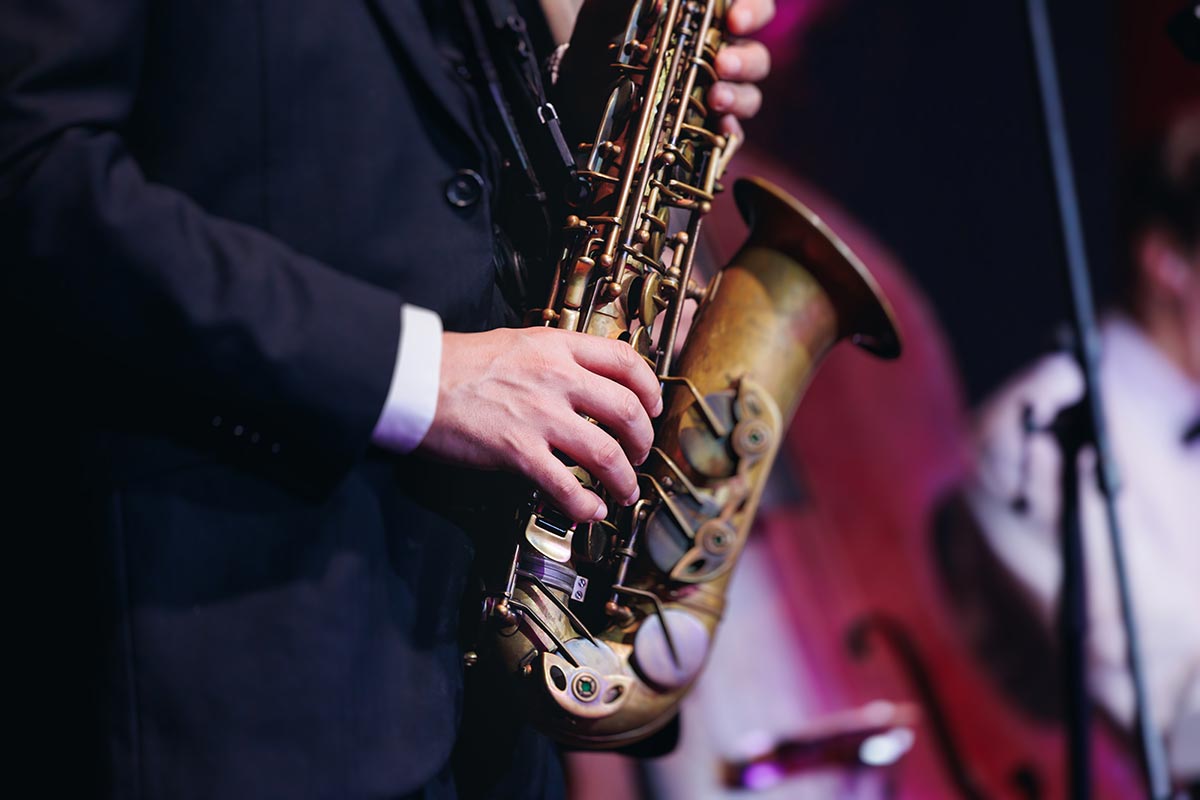 Closeup of a musician's hands playing a saxophone