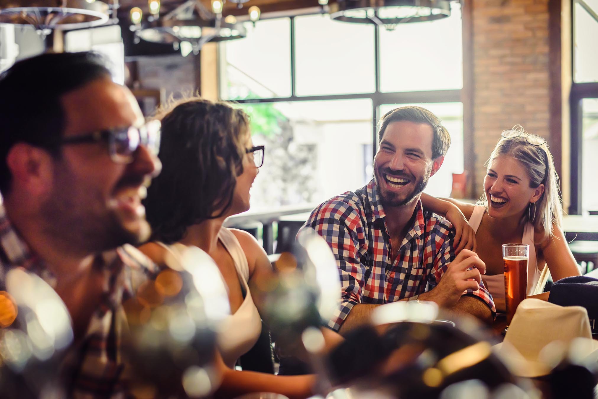 Group enjoying beers at bar